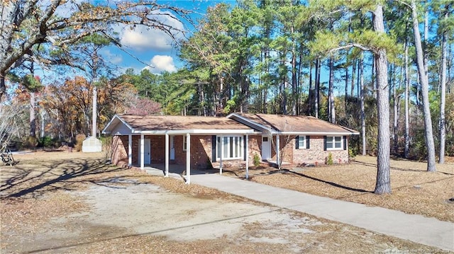 ranch-style house featuring a storage shed