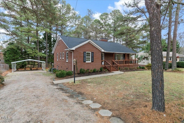 303 Forest Rd, Oxford, NC 27565 - single story home featuring a detached carport, covered porch, brick siding, a chimney, and a front lawn