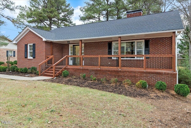 ranch-style house with a porch and a front lawn