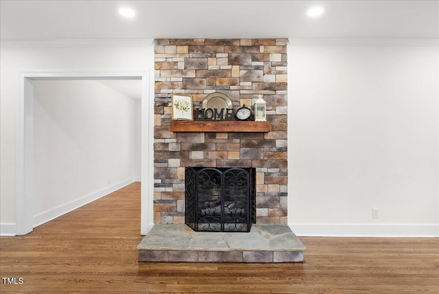 303 Forest Rd, Oxford, NC 27565 - detailed view of ornamental molding, a stone fireplace, wood finished floors, and recessed lighting
