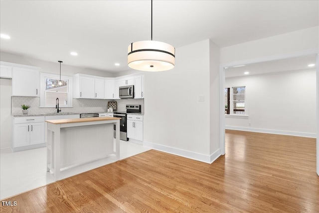 303 Forest Rd, Oxford, NC 27565 - kitchen with appliances with stainless steel finishes, light countertops, healthy amount of natural light, light wood-style flooring, and recessed lighting