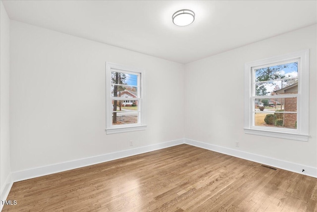 303 Forest Rd, Oxford, NC 27565 - unfurnished room featuring wood finished floors and plenty of natural light