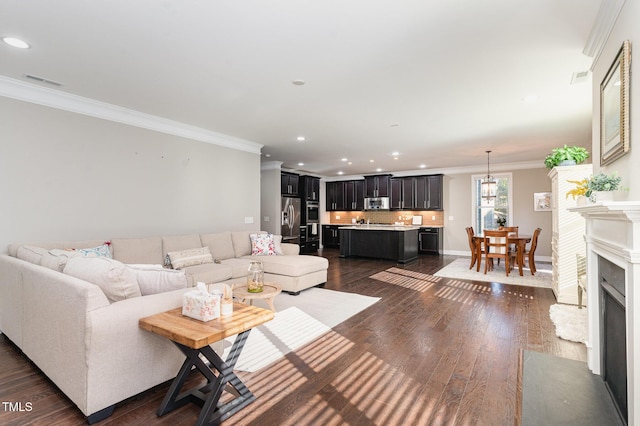 living room with dark wood-type flooring and ornamental molding