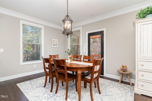 dining space with crown molding, dark hardwood / wood-style flooring, and an inviting chandelier