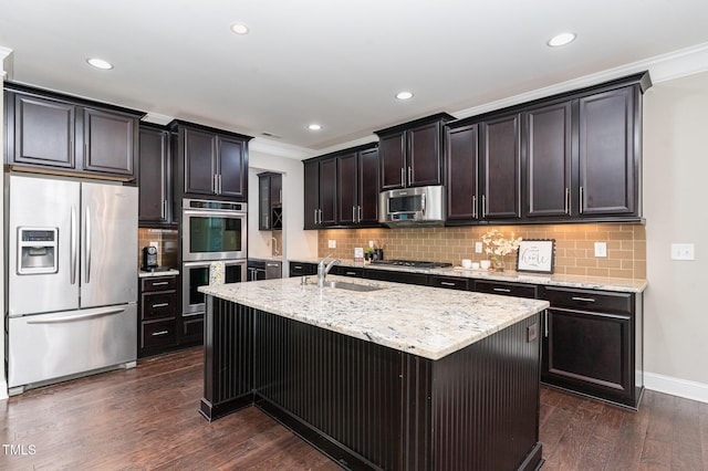 kitchen with sink, an island with sink, dark hardwood / wood-style flooring, light stone counters, and stainless steel appliances