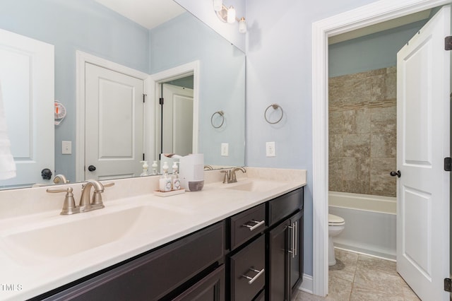 full bathroom featuring tile patterned floors, vanity, tiled shower / bath combo, and toilet