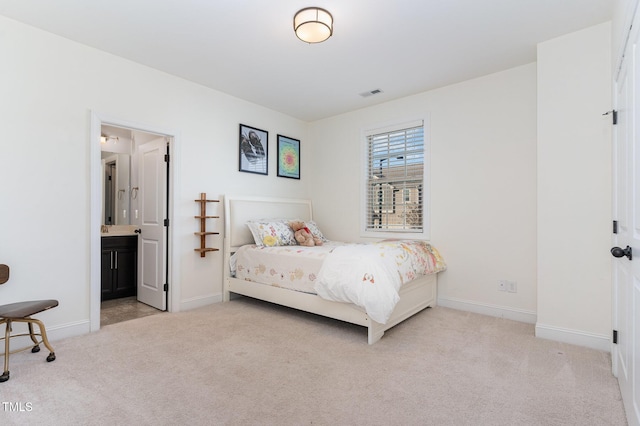 carpeted bedroom featuring connected bathroom