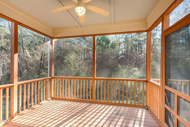 unfurnished sunroom with ceiling fan