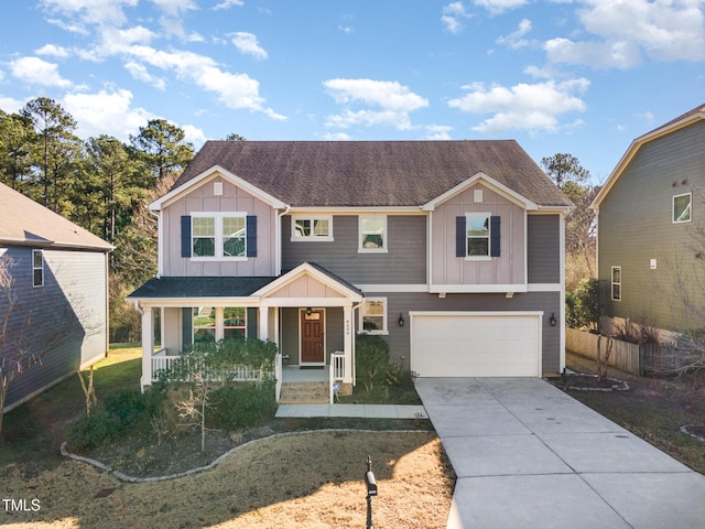 view of front of house with covered porch, a garage, and a front yard