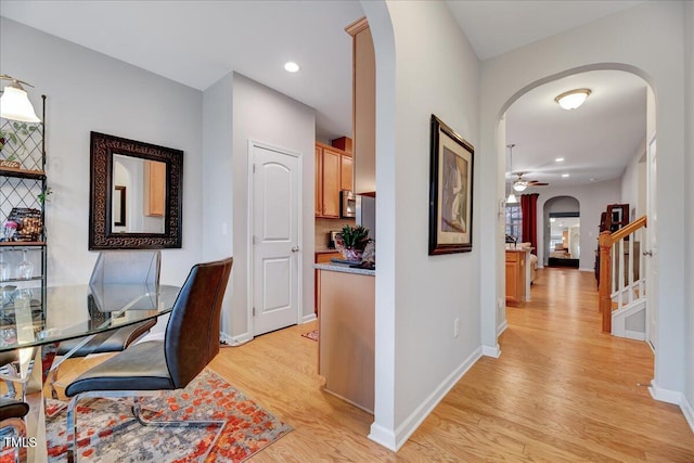 office with light hardwood / wood-style flooring and ceiling fan