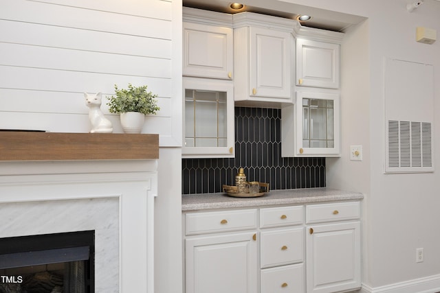 kitchen with white cabinets and decorative backsplash