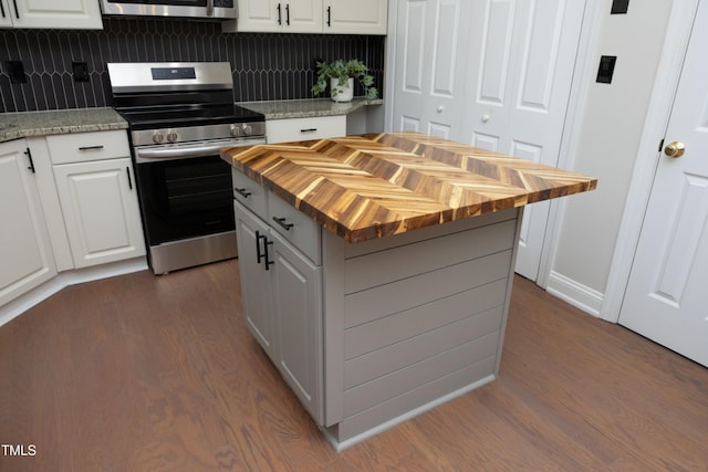 kitchen featuring white cabinets, dark hardwood / wood-style flooring, stainless steel appliances, and a kitchen island