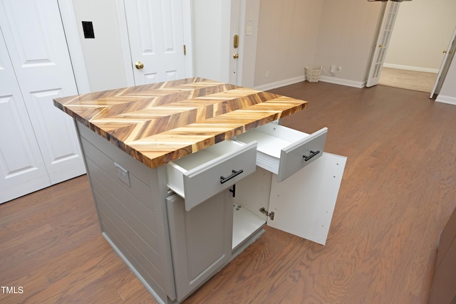 kitchen featuring gray cabinetry, wooden counters, and dark wood-type flooring