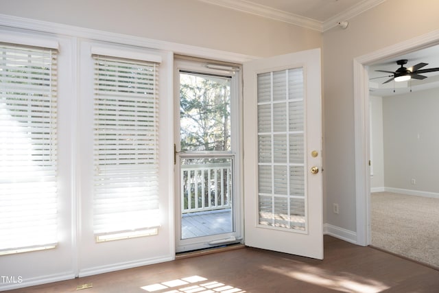 entryway with dark wood-type flooring, ceiling fan, and crown molding