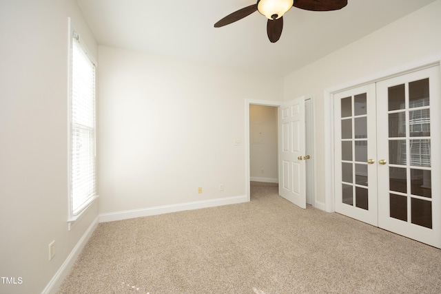 unfurnished room featuring carpet, french doors, and ceiling fan