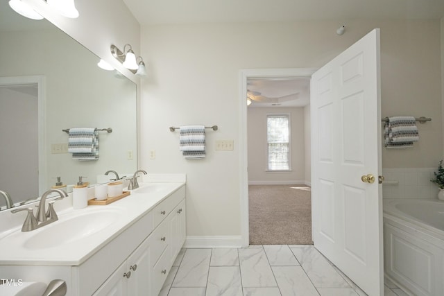 bathroom with vanity and a bath