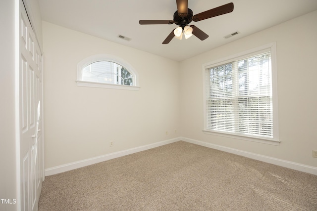 unfurnished room with carpet and ceiling fan