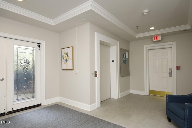 entrance foyer featuring crown molding and elevator