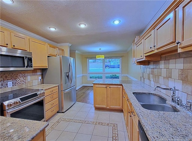 kitchen featuring appliances with stainless steel finishes, ornamental molding, sink, hanging light fixtures, and light tile patterned flooring