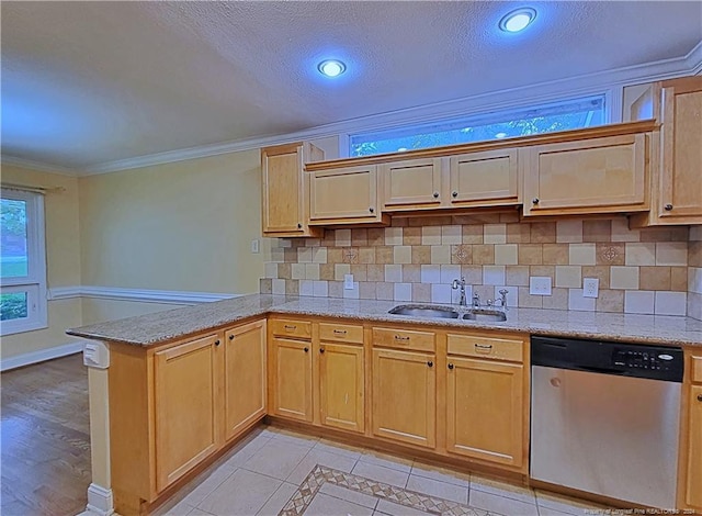 kitchen featuring kitchen peninsula, stainless steel dishwasher, crown molding, sink, and light tile patterned floors