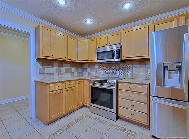 kitchen with decorative backsplash, crown molding, light tile patterned floors, and stainless steel appliances