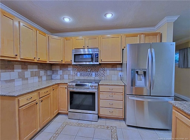 kitchen featuring crown molding, light tile patterned flooring, a textured ceiling, and appliances with stainless steel finishes