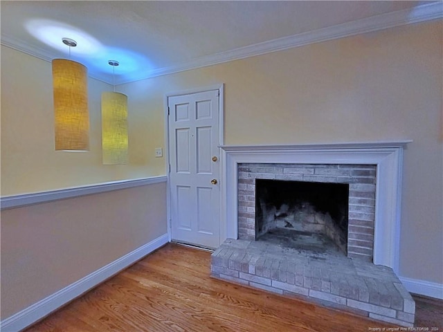 interior details with hardwood / wood-style floors, a brick fireplace, and crown molding