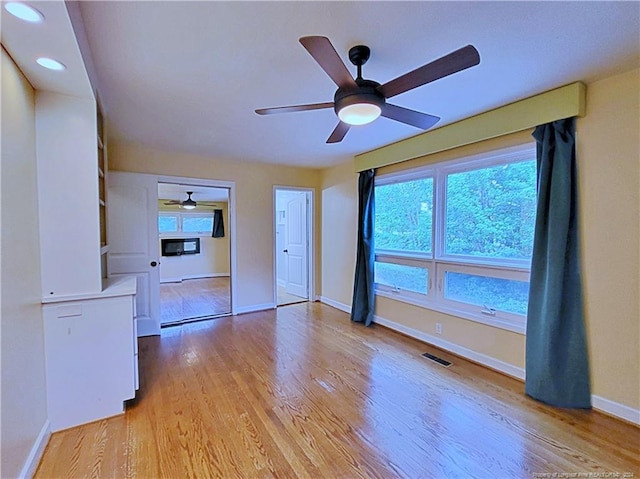 unfurnished living room with ceiling fan and light wood-type flooring