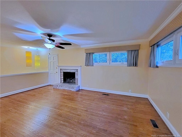 unfurnished living room featuring wood-type flooring, plenty of natural light, and crown molding