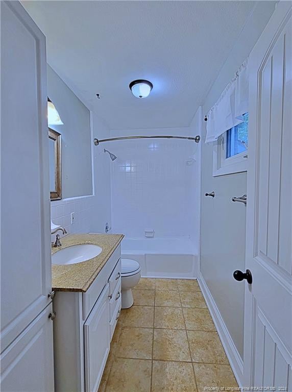 full bathroom with tile patterned floors, vanity, toilet, and washtub / shower combination