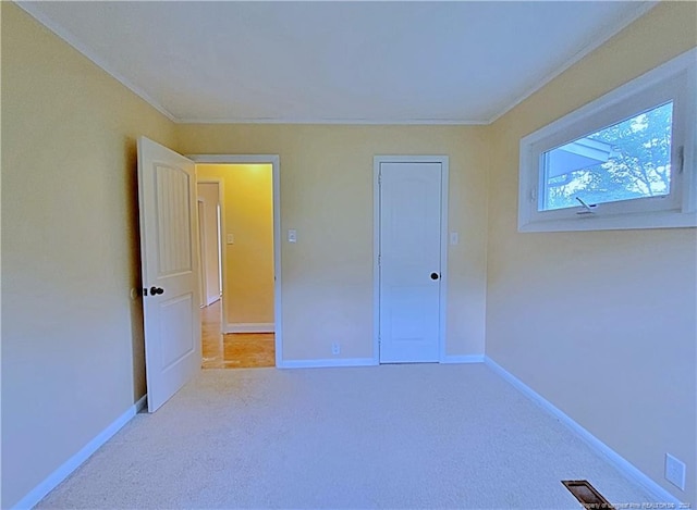 unfurnished bedroom featuring light colored carpet and a closet