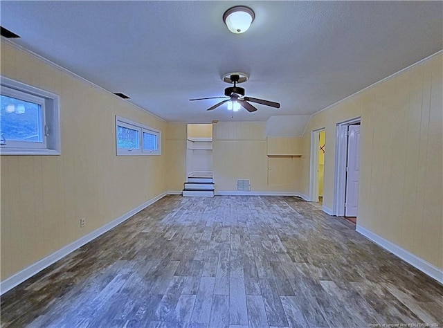 interior space featuring ceiling fan, dark hardwood / wood-style flooring, and ornamental molding