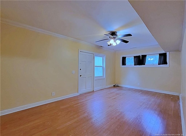 spare room featuring crown molding, hardwood / wood-style floors, and ceiling fan