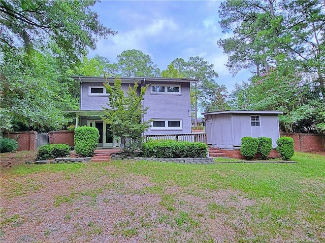 rear view of house with a yard