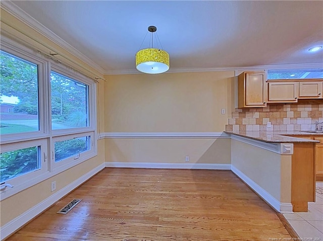 2519 Mirror Lake Dr, Fayetteville, NC 28303 - kitchen with tasteful backsplash, visible vents, pendant lighting, crown molding, and light wood finished floors