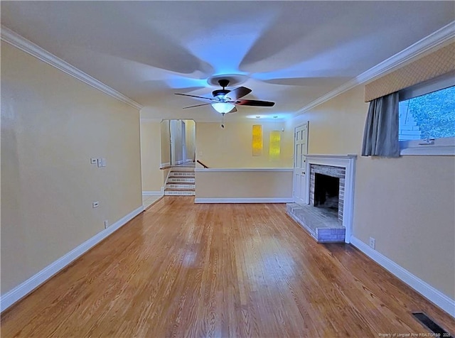 2519 Mirror Lake Dr, Fayetteville, NC 28303 - unfurnished living room featuring baseboards, a fireplace, crown molding, and wood finished floors