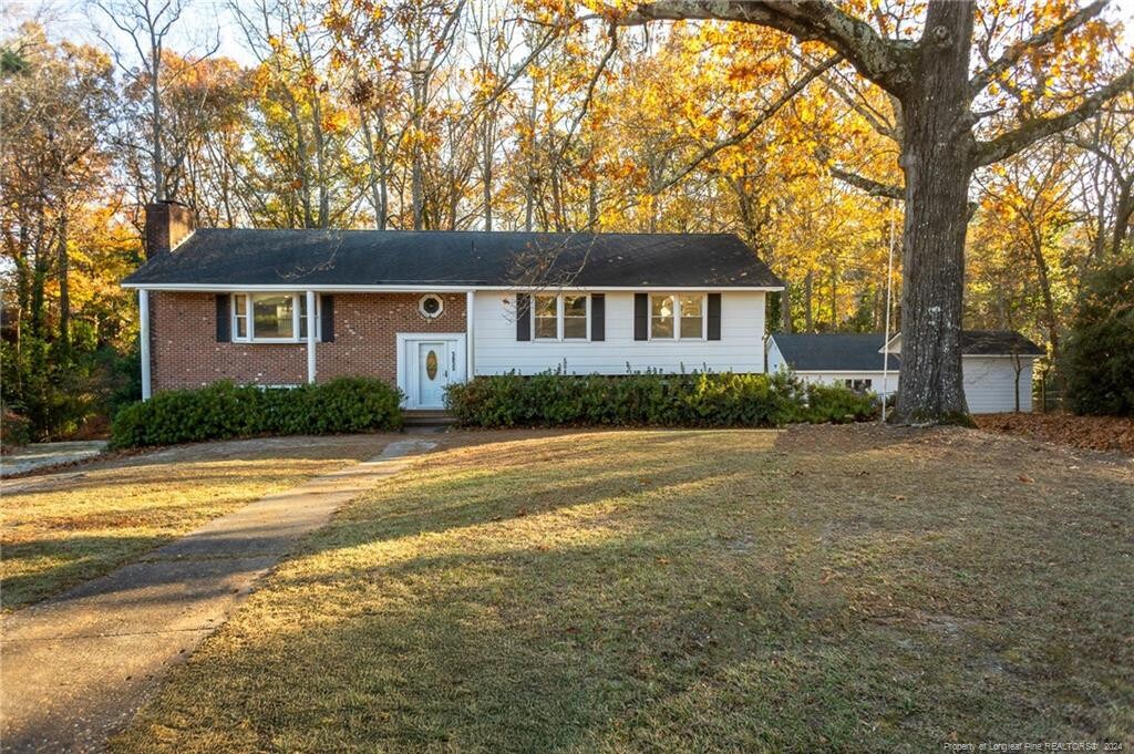 view of front of property with a front lawn and an outdoor structure