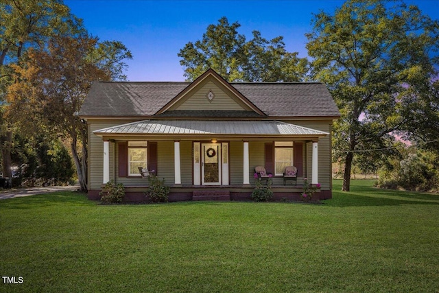 view of front of house with a porch and a front yard