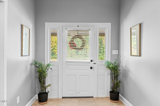 doorway with light tile patterned flooring