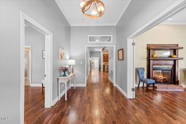 hall featuring a chandelier, crown molding, and dark hardwood / wood-style floors