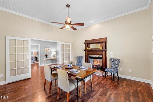 dining area featuring crown molding, french doors, a high end fireplace, and dark hardwood / wood-style floors