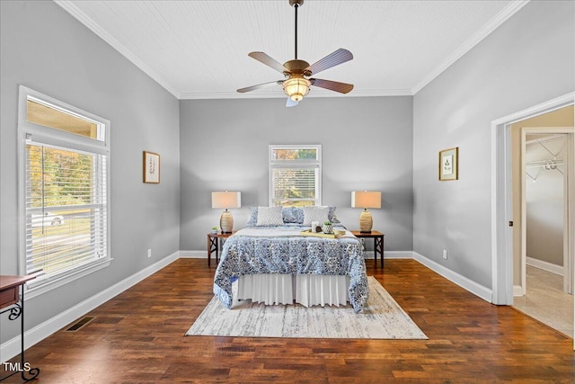 bedroom featuring dark wood-type flooring, ceiling fan, and crown molding