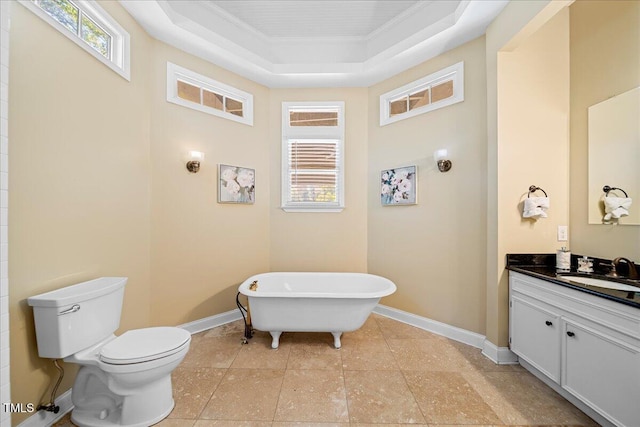 bathroom with toilet, a bathtub, vanity, a tray ceiling, and crown molding