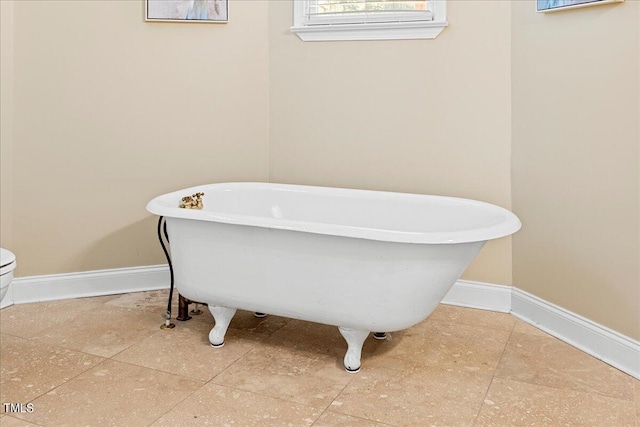 bathroom with toilet and a tub