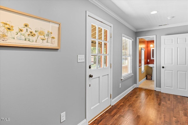 entryway with crown molding and dark hardwood / wood-style floors