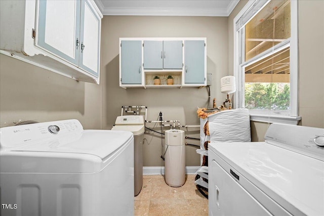 washroom with ornamental molding, cabinets, and washing machine and clothes dryer