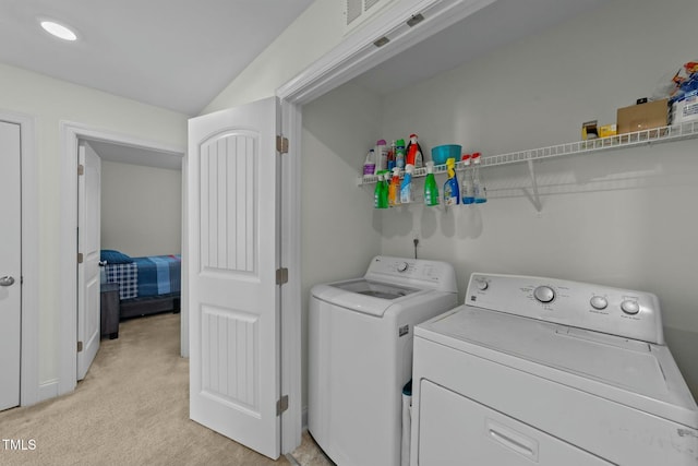 laundry area featuring washer and dryer and light carpet