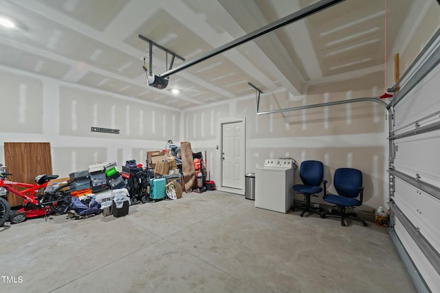 garage featuring washer / clothes dryer and a garage door opener