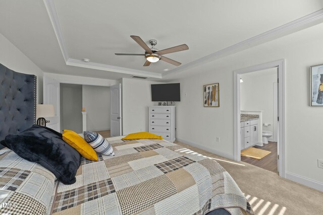 carpeted bedroom with ensuite bath, ceiling fan, and ornamental molding