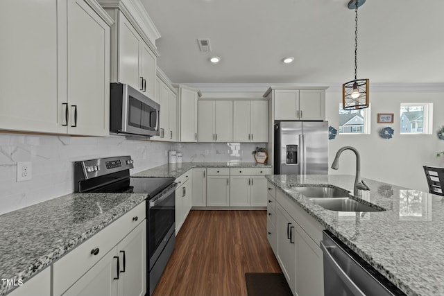 kitchen with white cabinetry, sink, stainless steel appliances, and decorative light fixtures